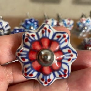Ceramic hand painted knobs. 34 flower shaped and 16 round. Assorted designs.